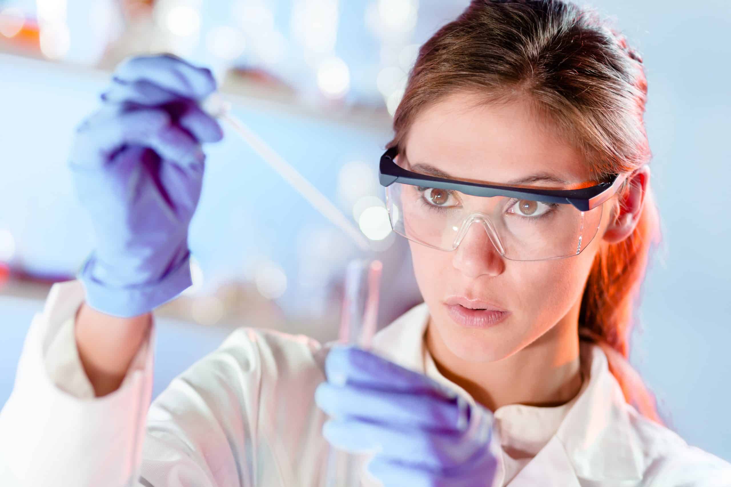 Young scientist pipetting in life science laboratory.