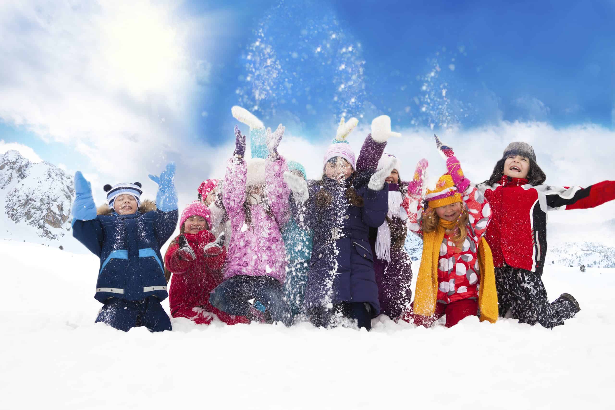 Group of happy kids throwing snow