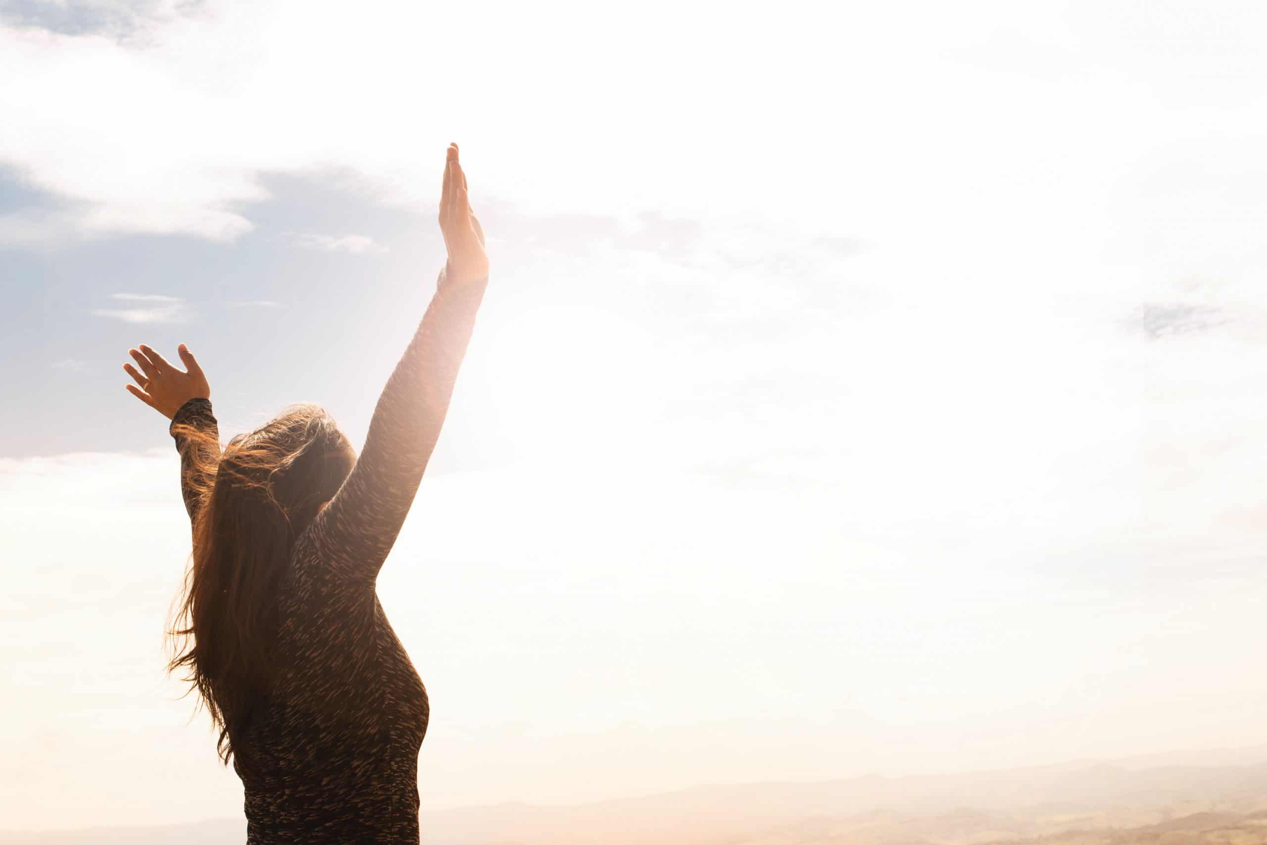 photo-of-woman-raising-both-hands-1556691